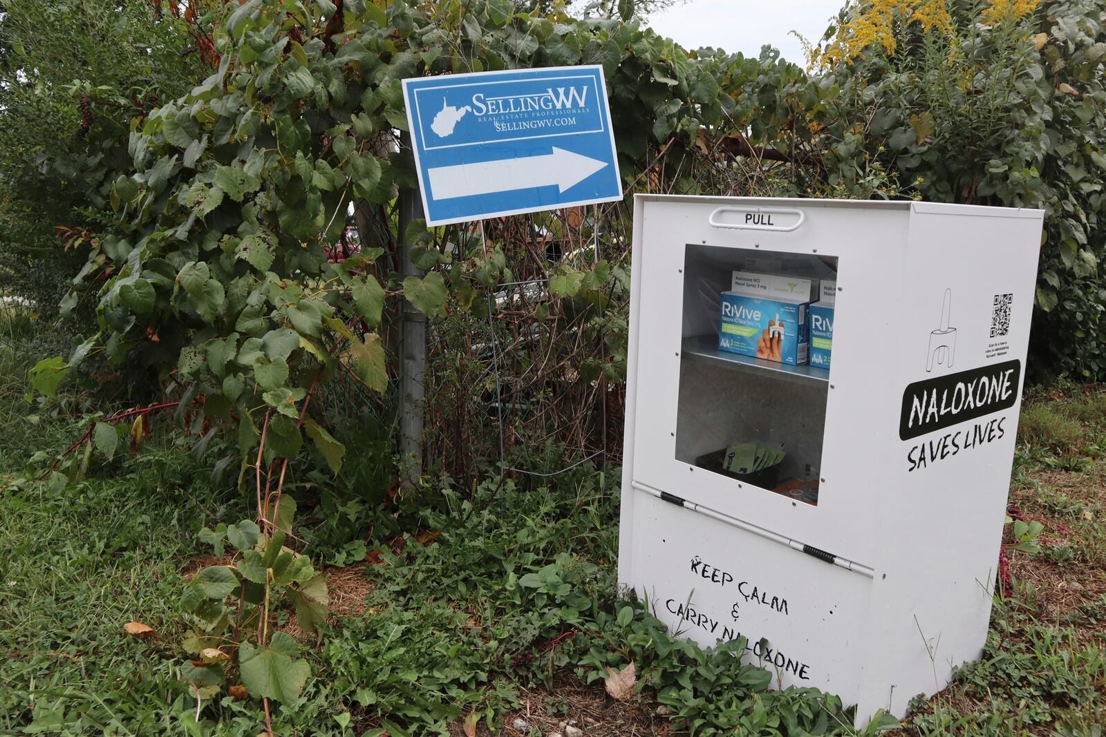 A new naloxone distribution box sits in a residential neighborhood in Hurricane, W.Va. on Tuesday, Sept. 24, 2024. (AP Photo/Leah Willingham)