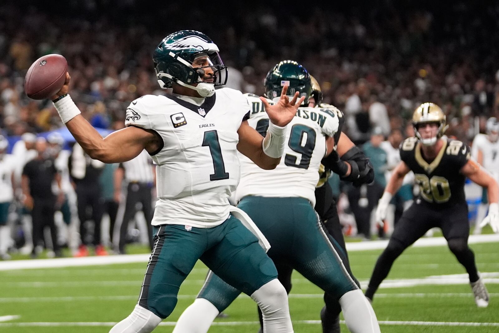 Philadelphia Eagles quarterback Jalen Hurts (1) passes against the New Orleans Saints in the first half of an NFL football game in New Orleans, Sunday, Sept. 22, 2024. (AP Photo/Gerald Herbert)