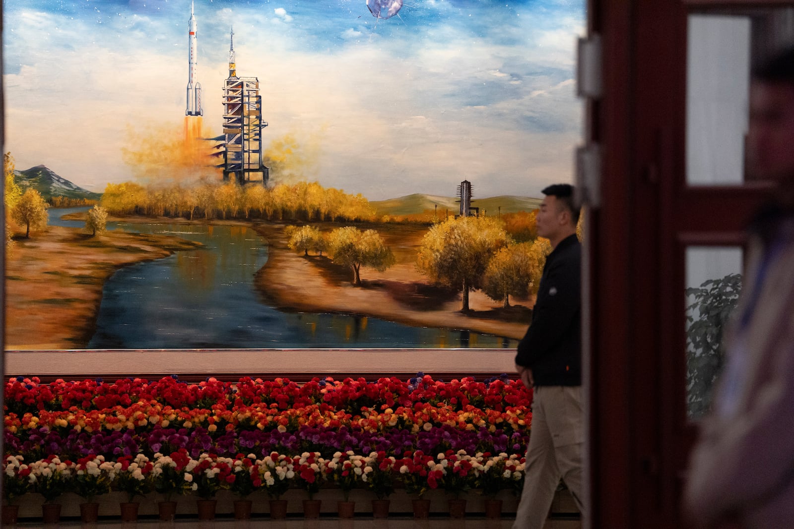 A mural depicting the launch of a Chinese space mission is seen before a press conference ahead of the Shenzhou-19 mission at the Jiuquan Satellite Launch Center in Jiuquan, northwestern China Tuesday, Oct. 29, 2024. (AP Photo/Ng Han Guan)