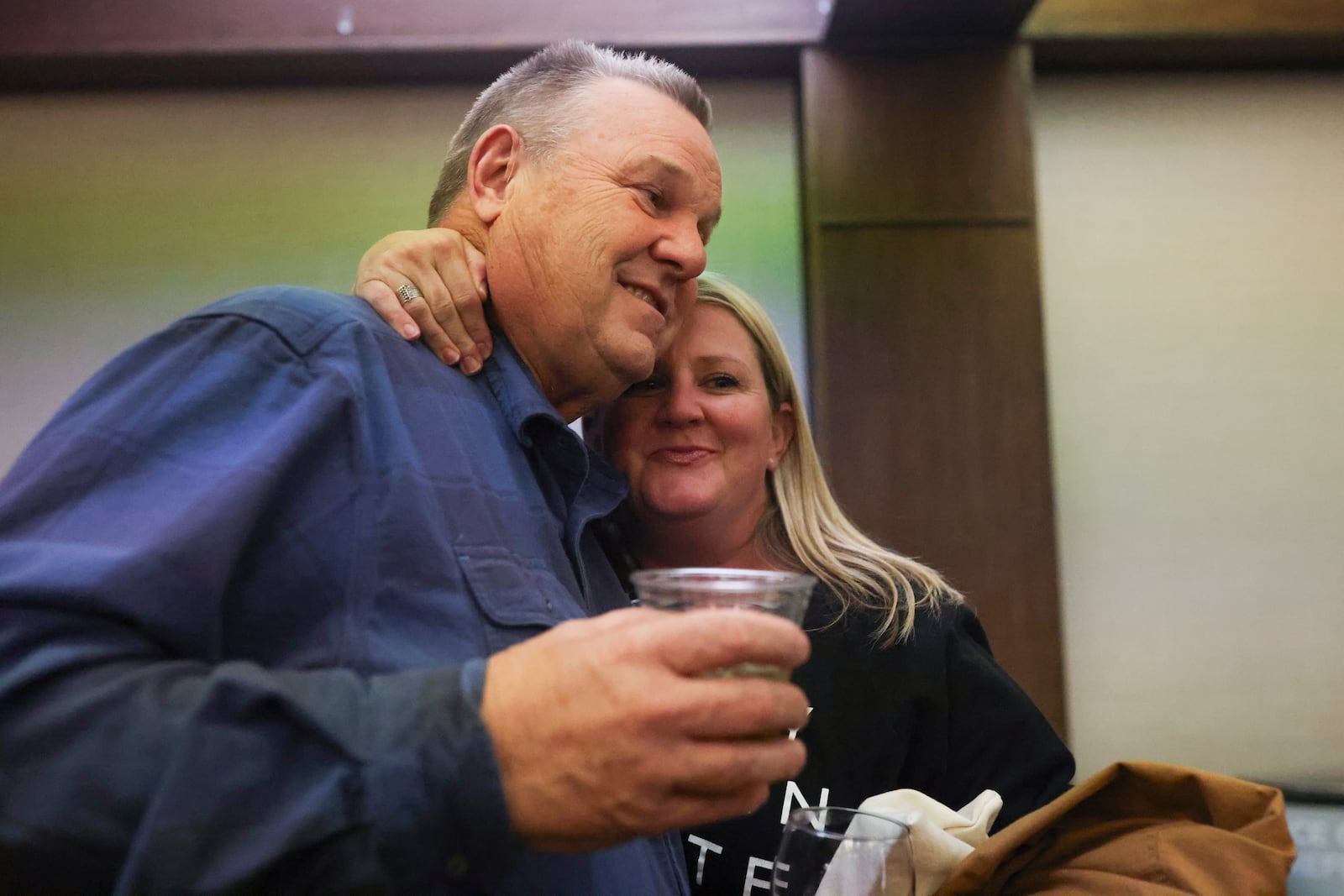 Sen. Jon Tester, D-Mont., left, receives a hug from supporter Brianne Laurin during an election night watch party Tuesday, Nov. 5, 2024, in Great Falls, Mont. (AP Photo/Mike Clark)