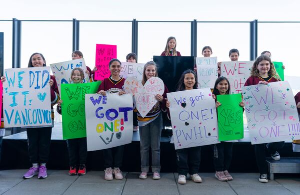 Member of the Vancouver Angels girls ice hockey team help announce that the PWHL will be expanding to Vancouver for the 2025-26 season during a press event in Vancouver, British Columbia, Wednesday April 23, 2025. (Rich Lam/The Canadian Press via AP)