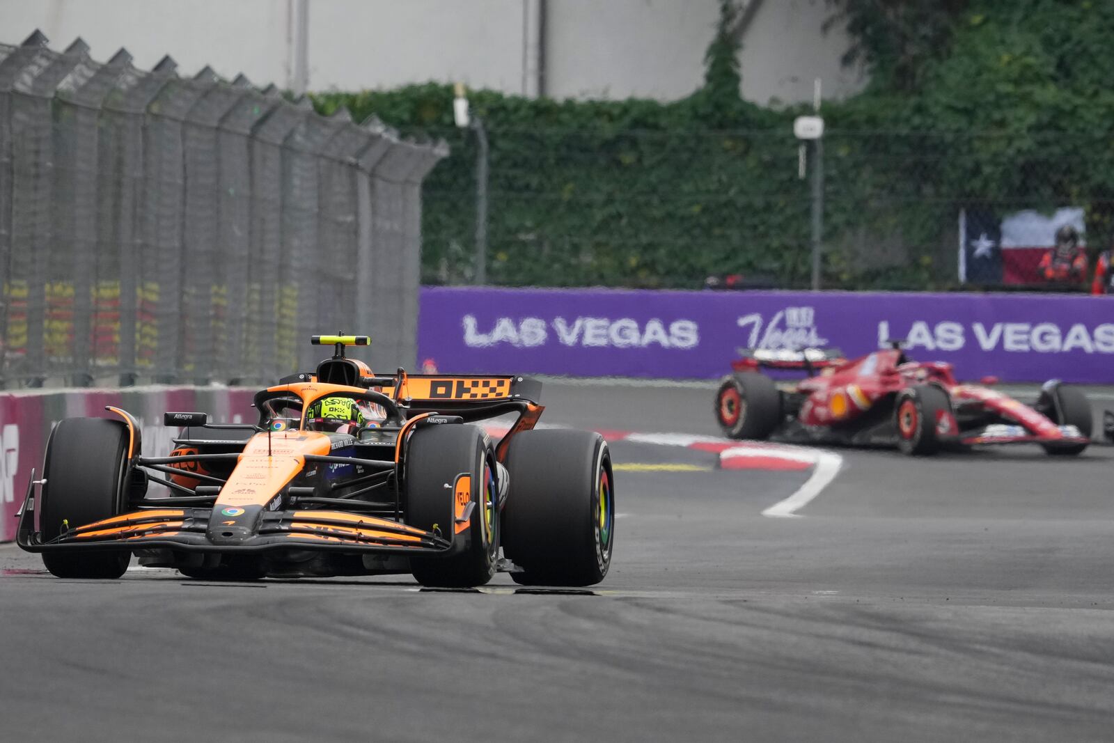 Lando Norris, of Britain, steers his McLaren followed by Ferrari driver Charles Leclerc of Monaco during the Formula One Mexico Grand Prix auto race at the Hermanos Rodriguez racetrack in Mexico City, Sunday, Oct. 27, 2024. (AP Photo/Fernando Llano)