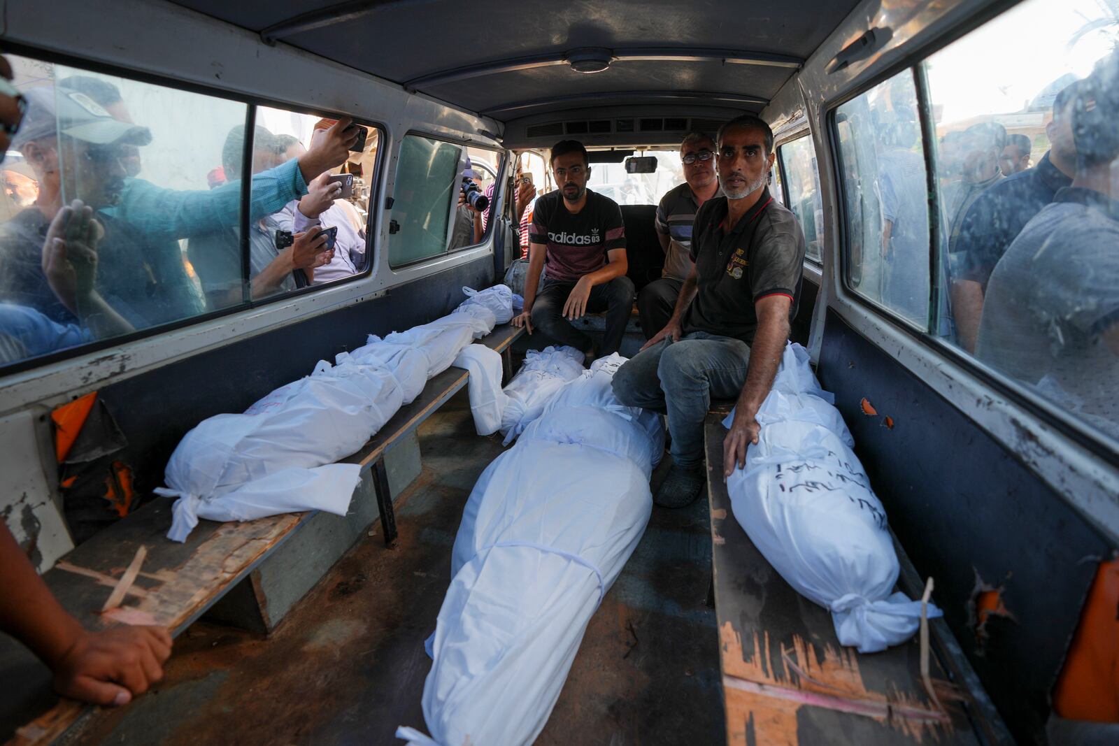 Mourners transport the bodies of their relatives killed in the Israeli bombardment of the Gaza Strip during their funeral in Deir al-Balah, Gaza, Monday, Sept. 23, 2024. (AP Photo/Abdel Kareem Hana)