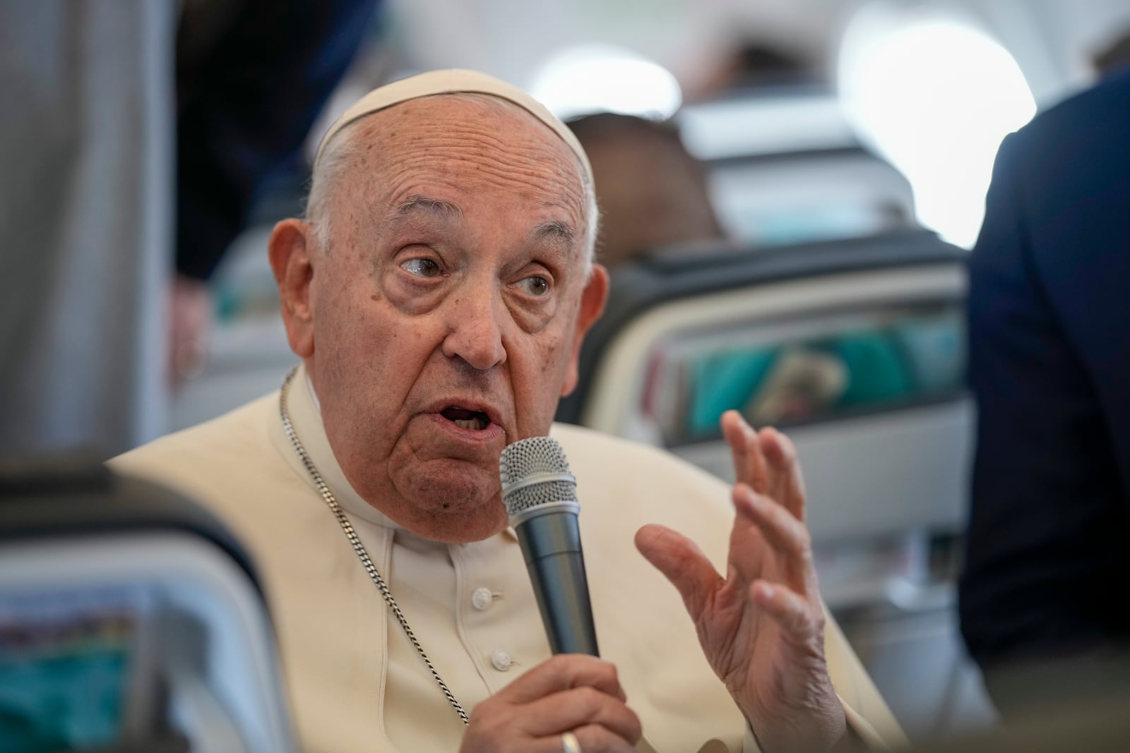 Pope Francis talks to journalists on the flight back to Rome at the end of his four-day visit to Belgium and Luxembourg, Sunday, Sept. 29, 2024. (AP Photo/Andrew Medichini, Pool)