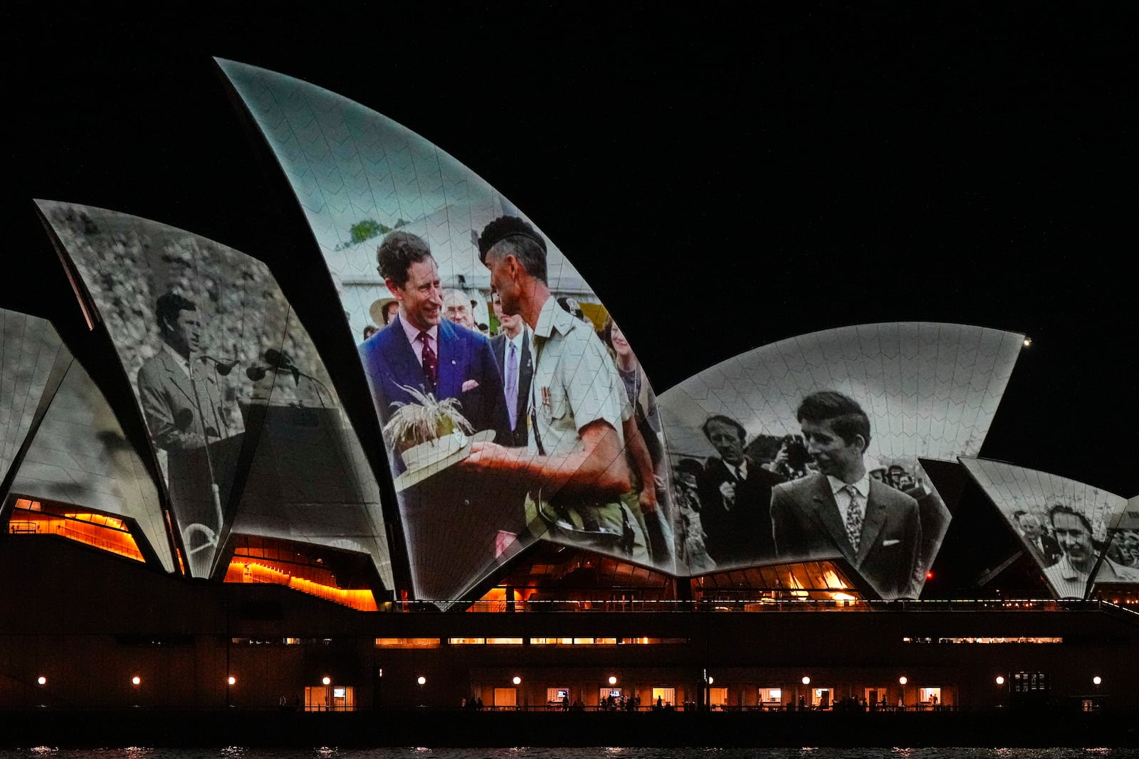 The Sydney Opera House sails show photos of Britain's King Charles soon after his arrival in Sydney, Australia, Friday, Oct. 18, 2024. (AP Photo/Mark Baker)