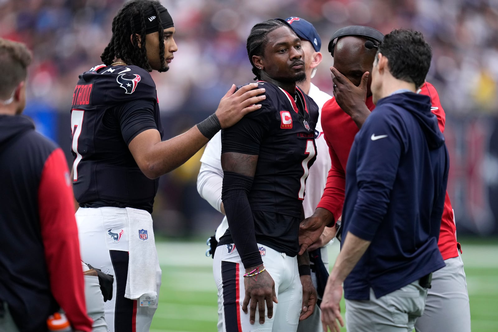 Houston Texans wide receiver Stefon Diggs (1) talks with quarterback C.J. Stroud, left, after getting injured during the second half of an NFL football game against the Indianapolis Colts, Sunday, Oct. 27, 2024, in Houston. (AP Photo/Eric Christian Smith)