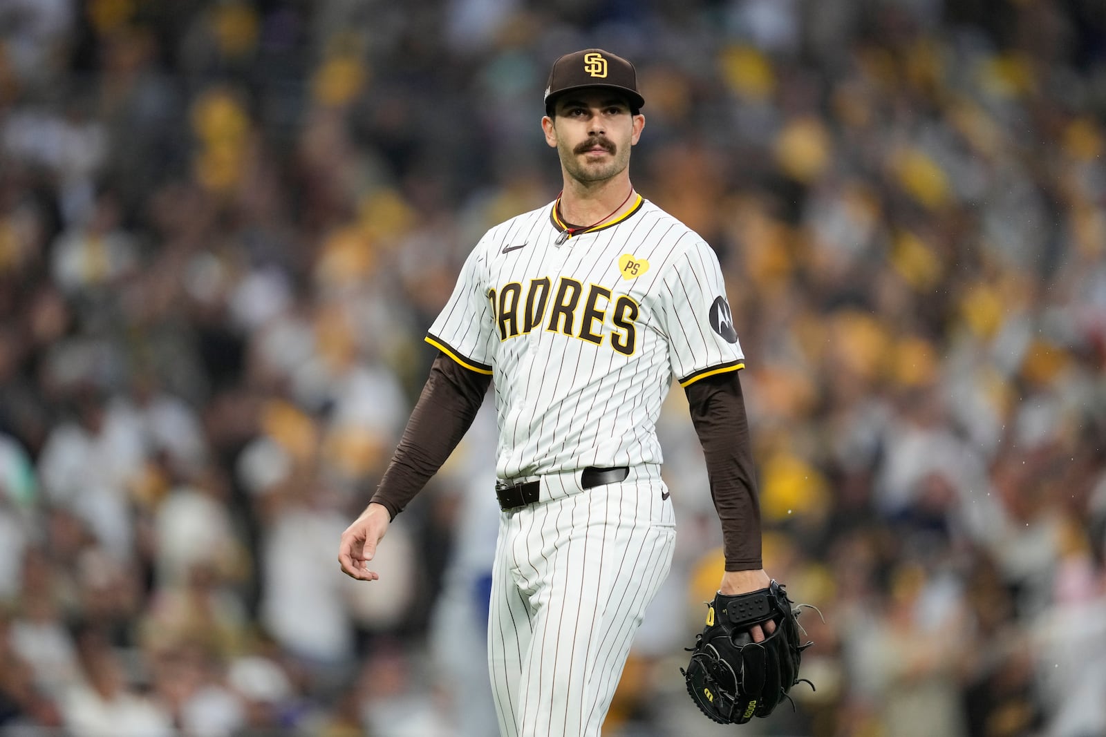 San Diego Padres starting pitcher Dylan Cease walks back to the dugout during the first inning in Game 4 of a baseball NL Division Series against the Los Angeles Dodgers, Wednesday, Oct. 9, 2024, in San Diego. (AP Photo/Ashley Landis)