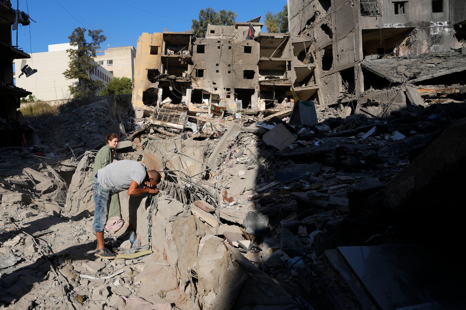 A man mourns at the site of the assassination of Hezbollah leader Hassan Nasrallah in Beirut's southern suburbs, Sunday, Sept. 29, 2024. (AP Photo/Hassan Ammar)