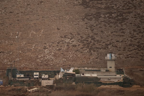 An UN soldier stands on the top of a tower at a base of the United Nations peacekeeping forces in Lebanon (UNIFIL) at the Israeli-Lebanese border as seen from northern Israel, Tuesday, Nov. 19, 2024. (AP Photo/Leo Correa)