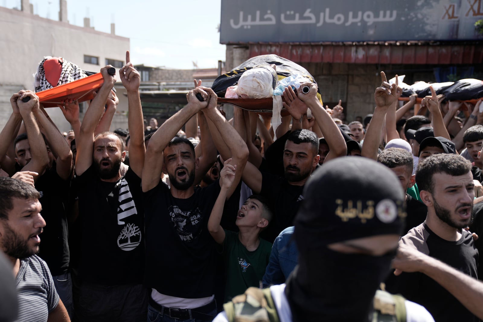 Mourners march during the funeral for three Palestinian militants killed in an Israeli military operation in the West Bank town of Qabatiya, Friday, Sept. 20, 2024. (AP Photo/Majdi Mohammed)