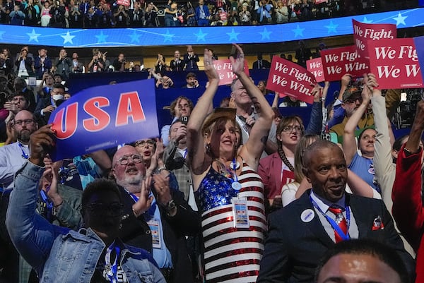 FILE - Jessie McGrath, center with hat, a transgender woman and a former Republican, cheers as she attends the Democratic National Convention as a delegate in Chicago, on Monday, Aug. 19, 2024. (AP Photo/Brynn Anderson, File)