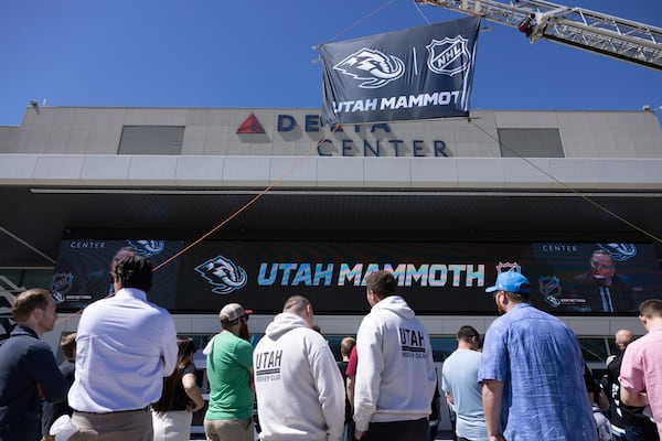 Fans watch outside Delta Center watch the live press conference announcing Utah Mammoth as the new name and branding identity of Utah's NHL franchise, Wednesday, May 7, 2025, in Salt Lake City. (AP Photo/Melissa Majchrzak)