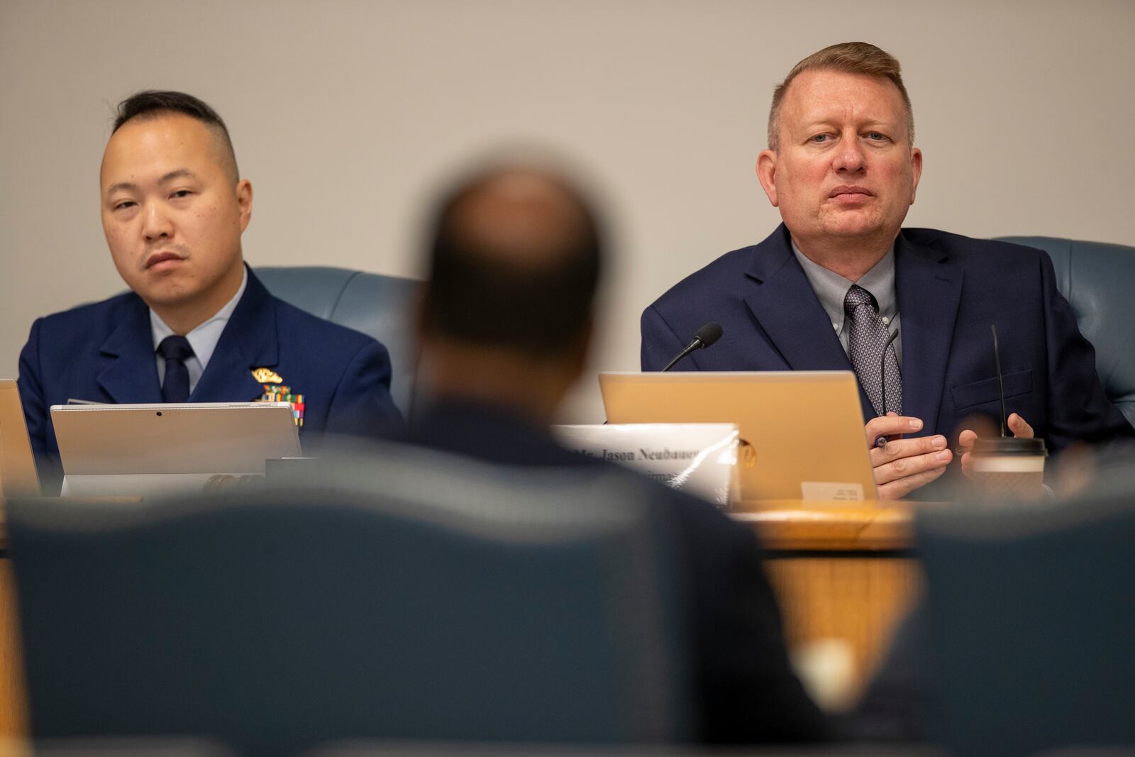 Gim Kang, special counsel, left, and Jason Neubauer, board chairman, listen to Roy Thomas during his testimony at the Coast Guard's Titan Submersible Marine Board of Investigation formal hearing inside the Charleston County Council Chambers, Monday, Sept. 23, 2024, in North Charleston, S.C. (Laura Bilson/The Post And Courier via AP, Pool)