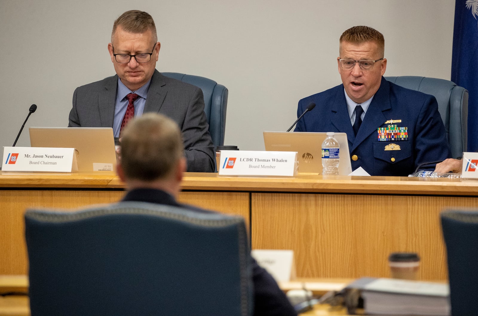 Board Chairman Jason Neubauer, left, and board member Thomas Whalen, of the investigative board for the Titan marine board formal hearing, speak with former OceanGate's Director of Marine Operations David Lochridge, foreground, Tuesday, Sept. 17, 2024, in North Charleston, S.C. (Andrew J. Whitaker/The Post And Courier via AP, Pool)