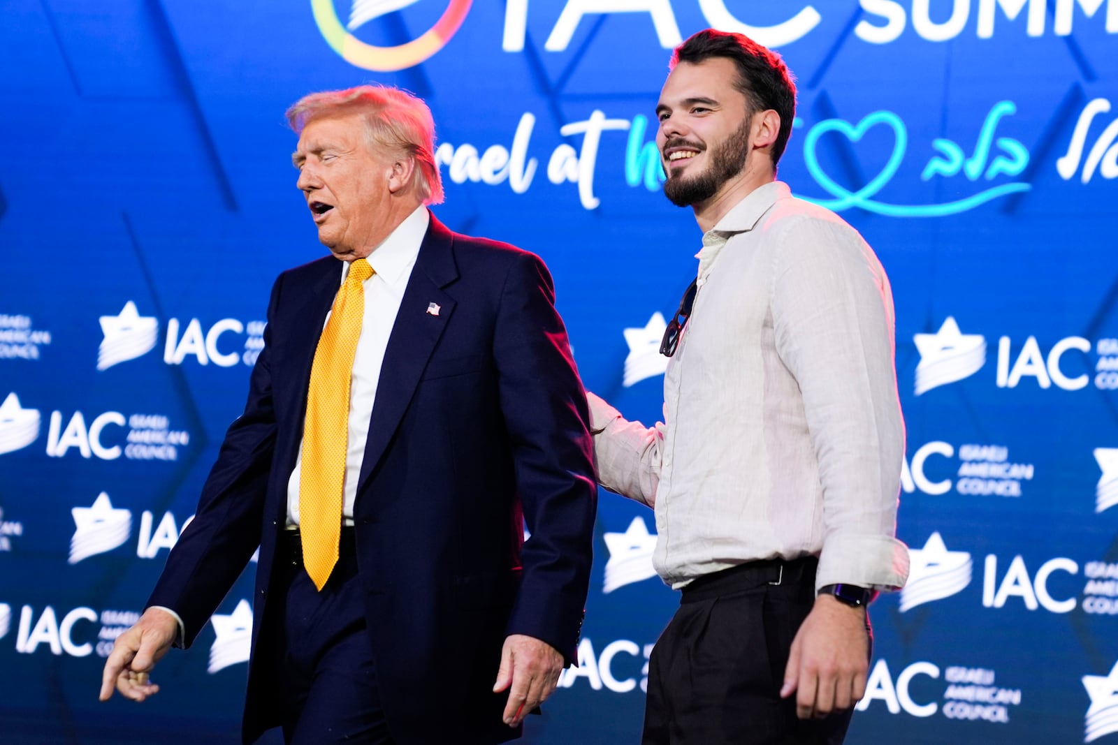 Republican presidential candidate former President Donald Trump greets Andrey Koslov, an Israeli who was taken hostage by Hamas on Oct. 7, 2023 and rescued by by Israeli special forces on June 8, 2024, at the Israeli American Council National Summit, Thursday, Sept. 19, 2024, in Washington. (AP Photo/Evan Vucci)