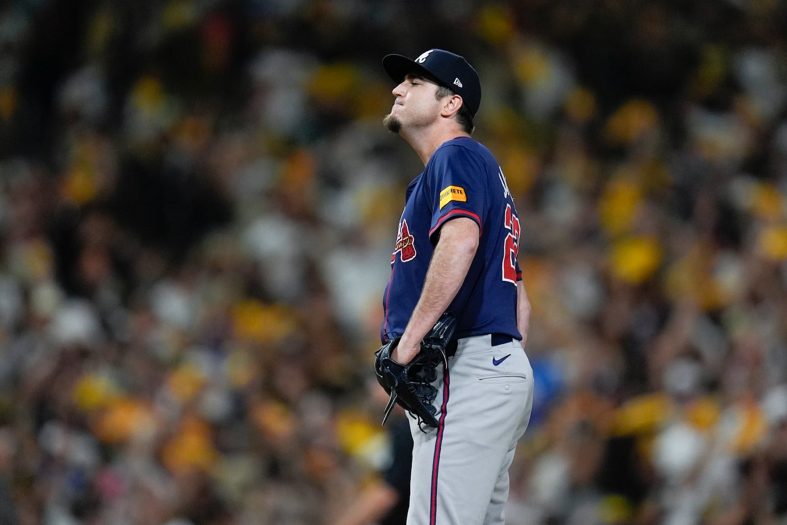 Atlanta Braves pitcher Luke Jackson stands on the mound after giving up a solo home run to San Diego Padres' Kyle Higashioka during the eighth inning in Game 1 of an NL Wild Card Series baseball game Tuesday, Oct. 1, 2024, in San Diego. (AP Photo/Gregory Bull)