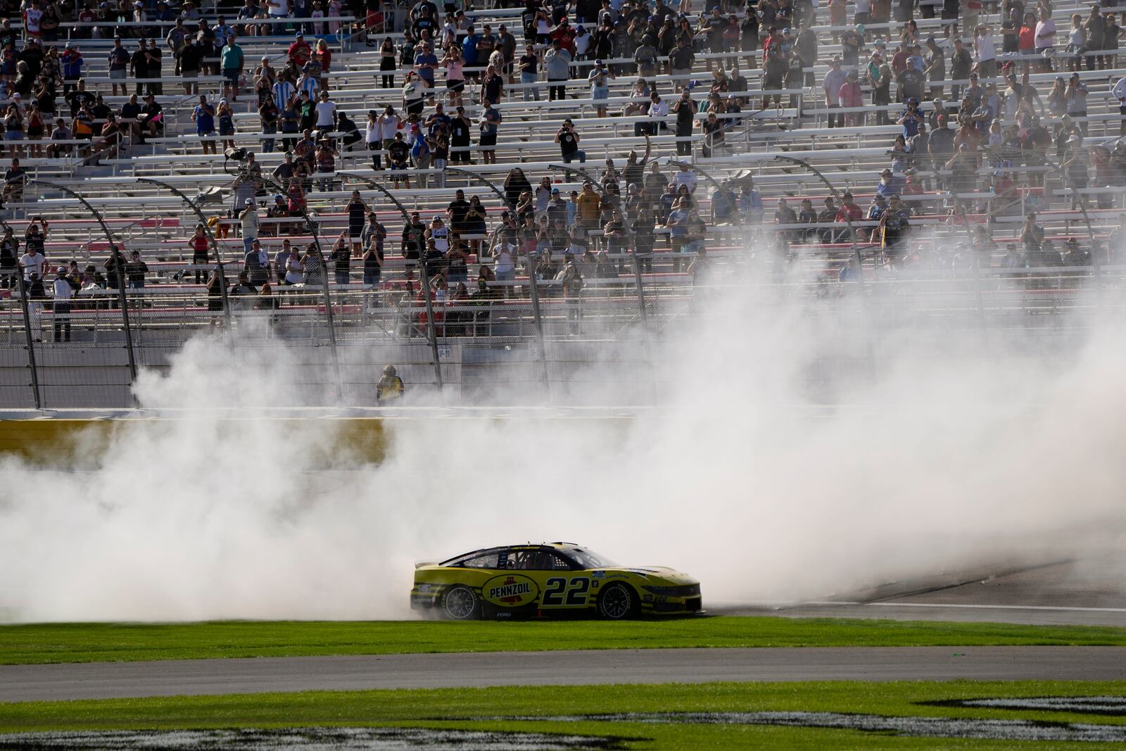 NASCAR Cup Series driver Joey Logano (22) does a burnout after winning a NASCAR Cup Series auto race Sunday, Oct. 20, 2024, in Las Vegas. (AP Photo/John Locher)