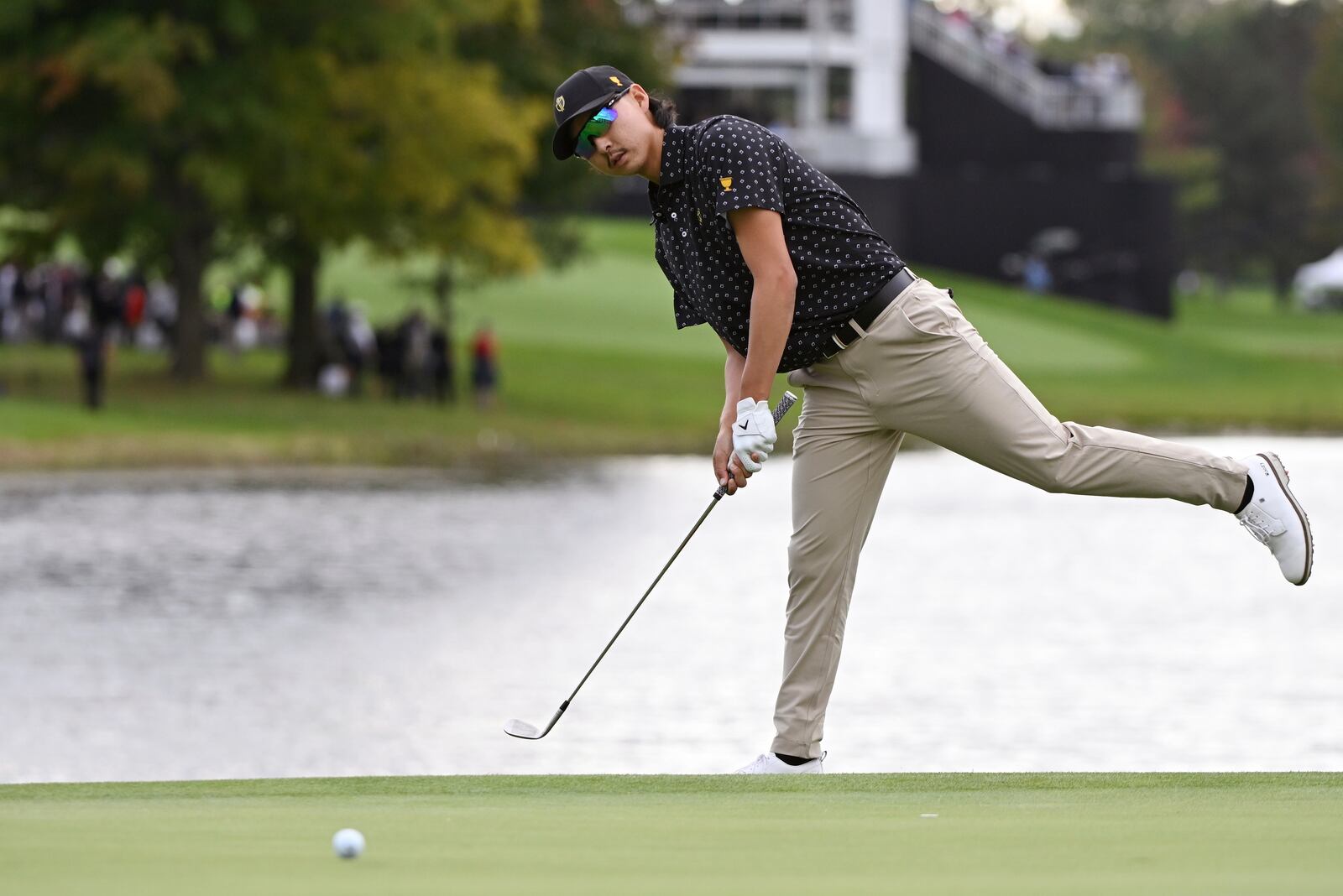 International team member Min Woo Lee, of Australia, reacts to his putt on the 15th green during a first round four-ball match at the Presidents Cup golf tournament at the Royal Montreal Golf Club in Montreal, Thursday, Sept. 26, 2024. (Graham Hughes/The Canadian Press via AP)