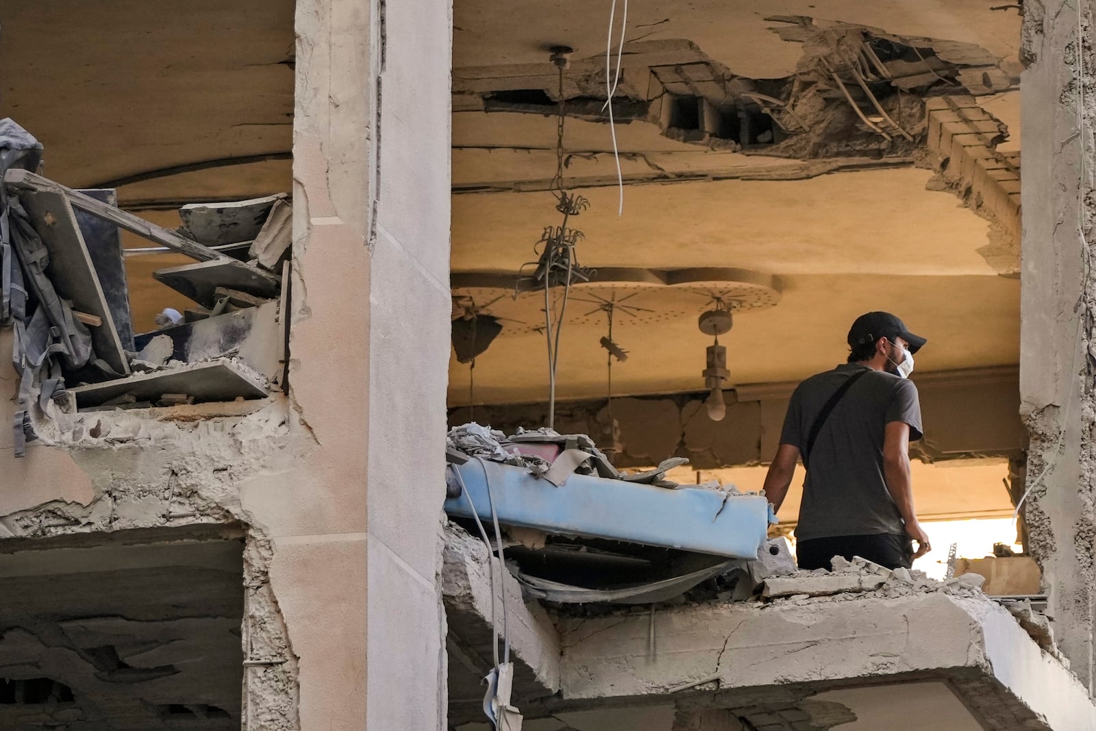 A resident checks an apartment that was hit by an Israeli airstrike in Beirut's southern suburbs, Thursday, Sept. 26, 2024. (AP Photo/Hassan Ammar)