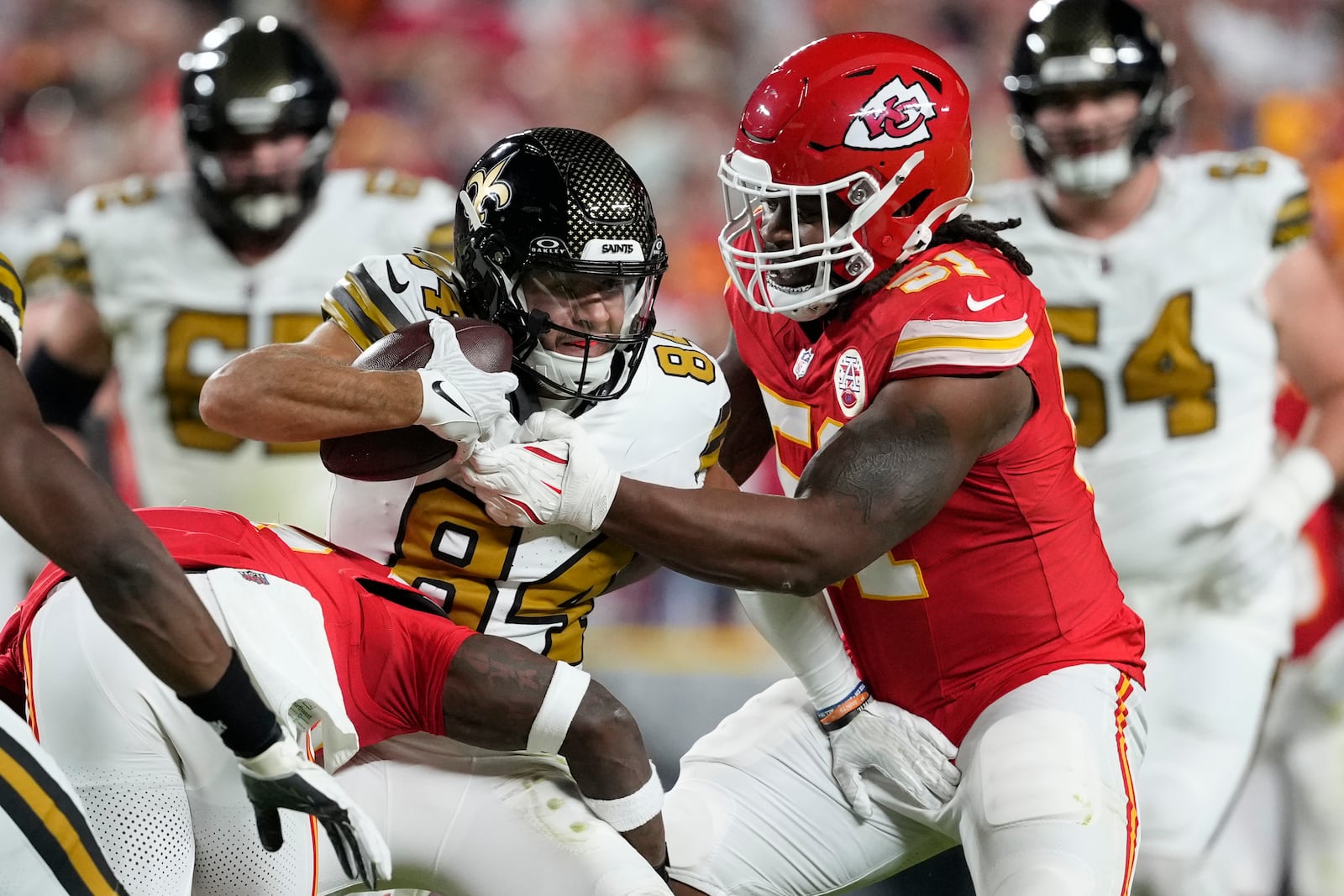 New Orleans Saints wide receiver Mason Tipton (84) is stopped by Kansas City Chiefs defensive end Mike Danna (51) during the second half of an NFL football game Monday, Oct. 7, 2024, in Kansas City, Mo. (AP Photo/Ed Zurga)