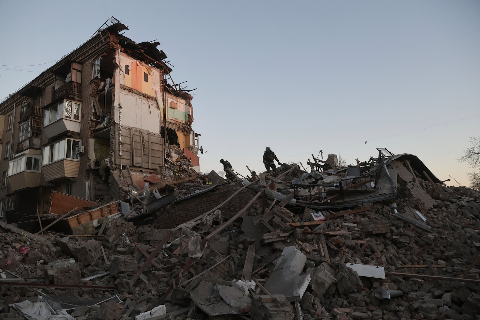 Rescue workers clear the rubble of a residential building destroyed by a Russian airstrike in Zaporizhzhia, Ukraine, Thursday, Nov. 7, 2024. (AP Photo/Kateryna Klochko)