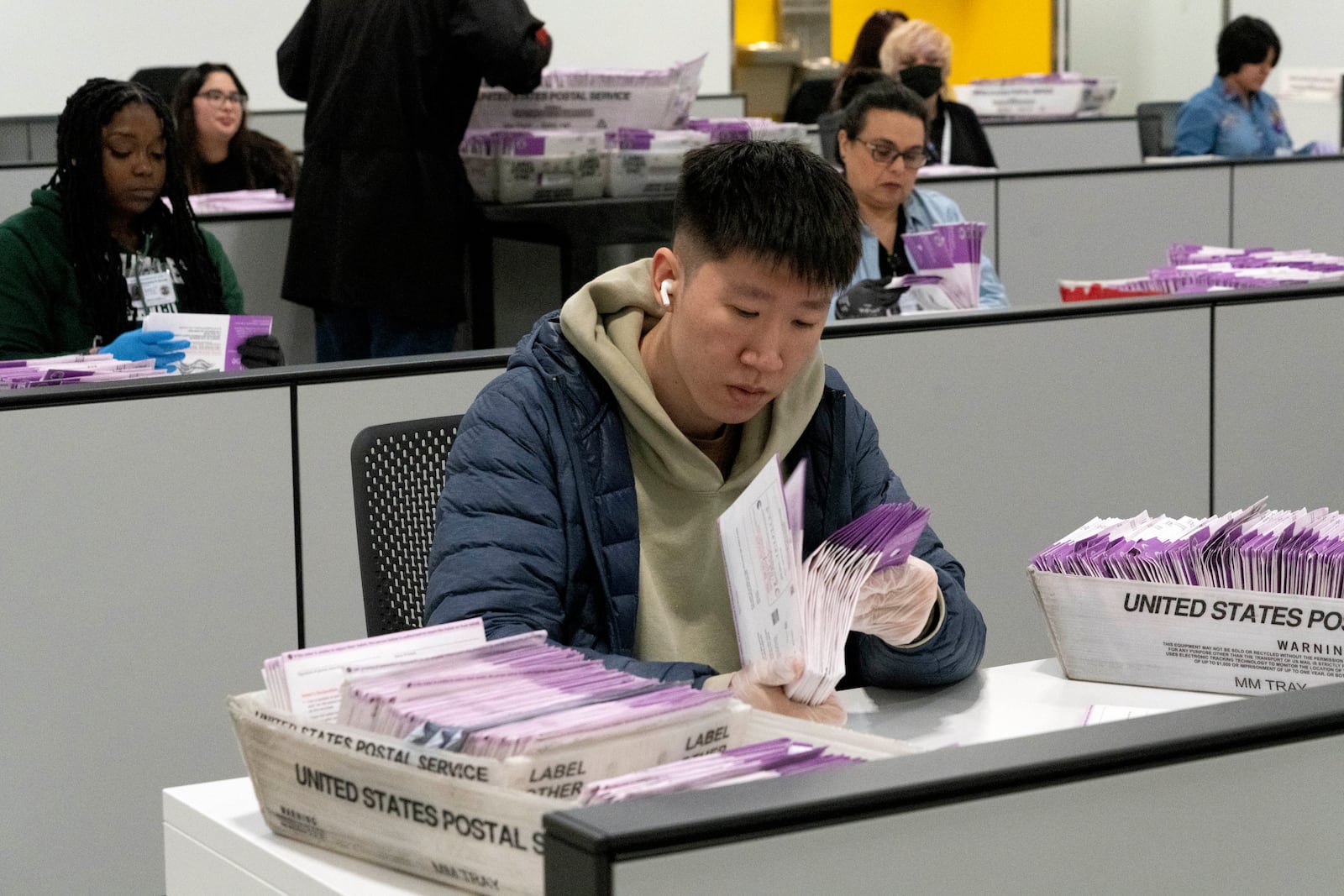 FILE - Workers check on signed signatures on mail-in ballots at the new Los Angeles County Ballot Processing Center in the City of Industry, Calif., Thursday, Feb. 29, 2024. (AP Photo/Richard Vogel, File)