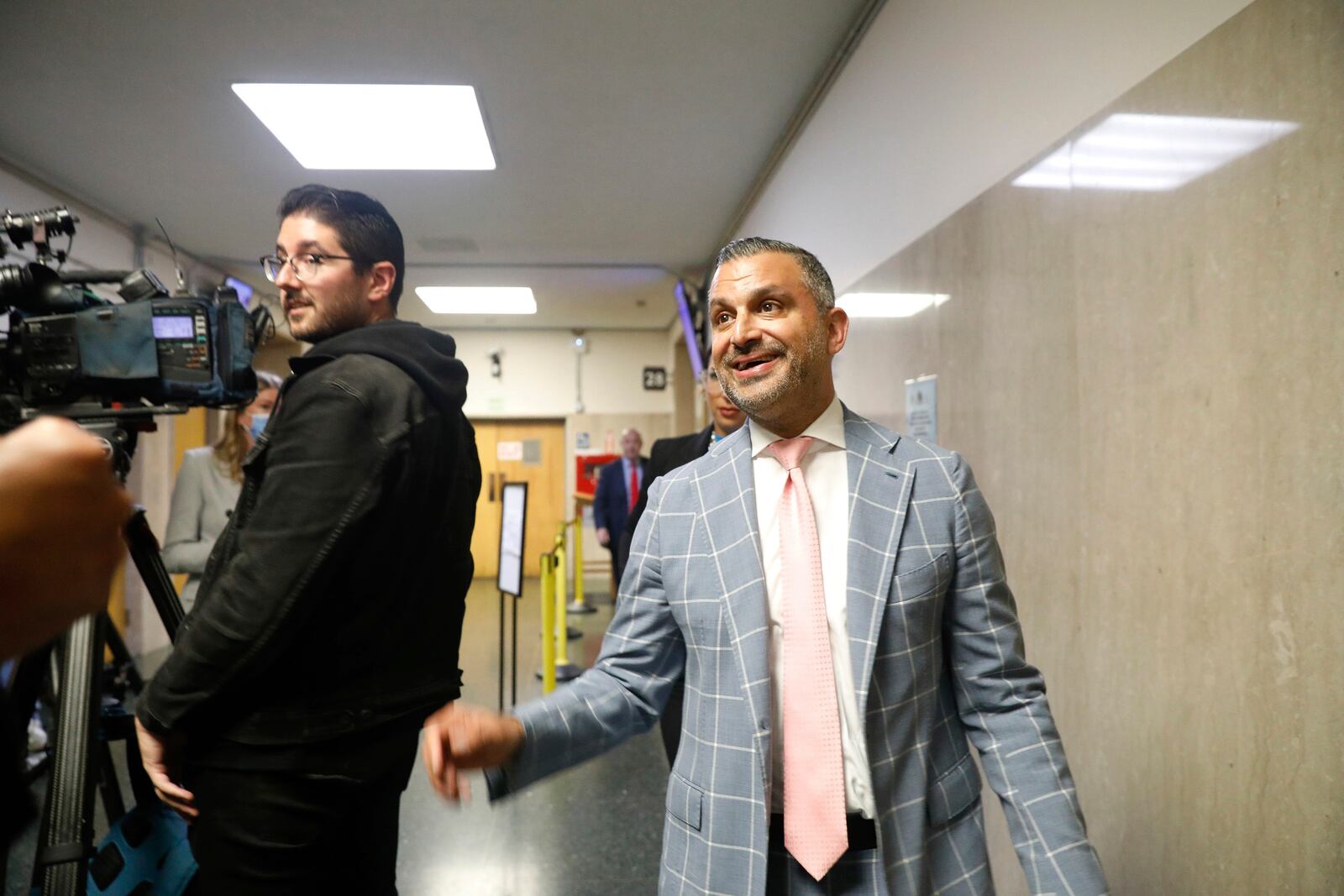 Attorney Saam Zangeneh walks past members of the media in the hallway outside Department 28 at the Hall of Justice on the first day of the trial of Nima Momeni, on the first day of the trial of Nima Momeni, a tech consultant charged in the stabbing death of Cash App founder Bob Lee, Monday, Oct. 14, 2024, in San Francisco. Momeni has pleaded not guilty. (Lea Suzuki/San Francisco Chronicle via AP)