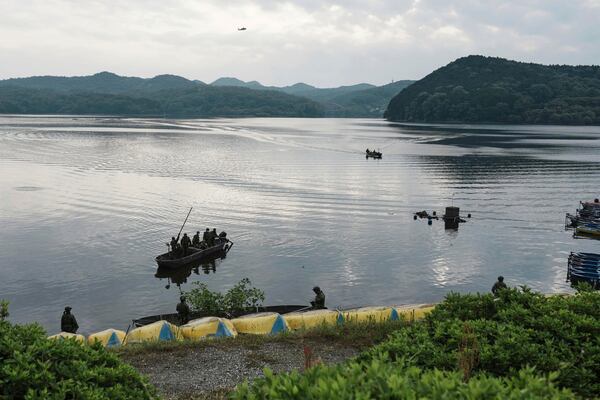 Members of Japan's Self-Defense Forces conduct a search for crew members at a reservoir in Inuyama, central Japan, Thursday, May 15, 2025, following the crash of an Air Self-Defense Force trainer jet Wednesday. (Koji Harada/Kyodo News via AP)