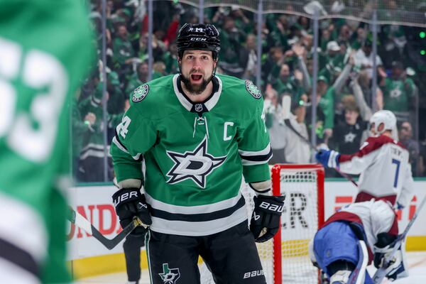 Dallas Stars left wing Jamie Benn (14) celebrates with center Wyatt Johnston, left, after scoring during the first period of Game 5 of a first-round NHL hockey playoff series against the Colorado Avalanche in Dallas, Monday, April 28, 2025. (AP Photo/Gareth Patterson)