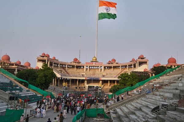 People gather near the closed gates for selfie after a daily closing ceremony by Pakistan's Rangers and Indian Border Security Forces soldiers, at the Wagah, a joint post on the Pakistan and India border, near Lahore, Pakistan, Saturday, May 3, 2025. (AP Photo/K.M. Chaudary)