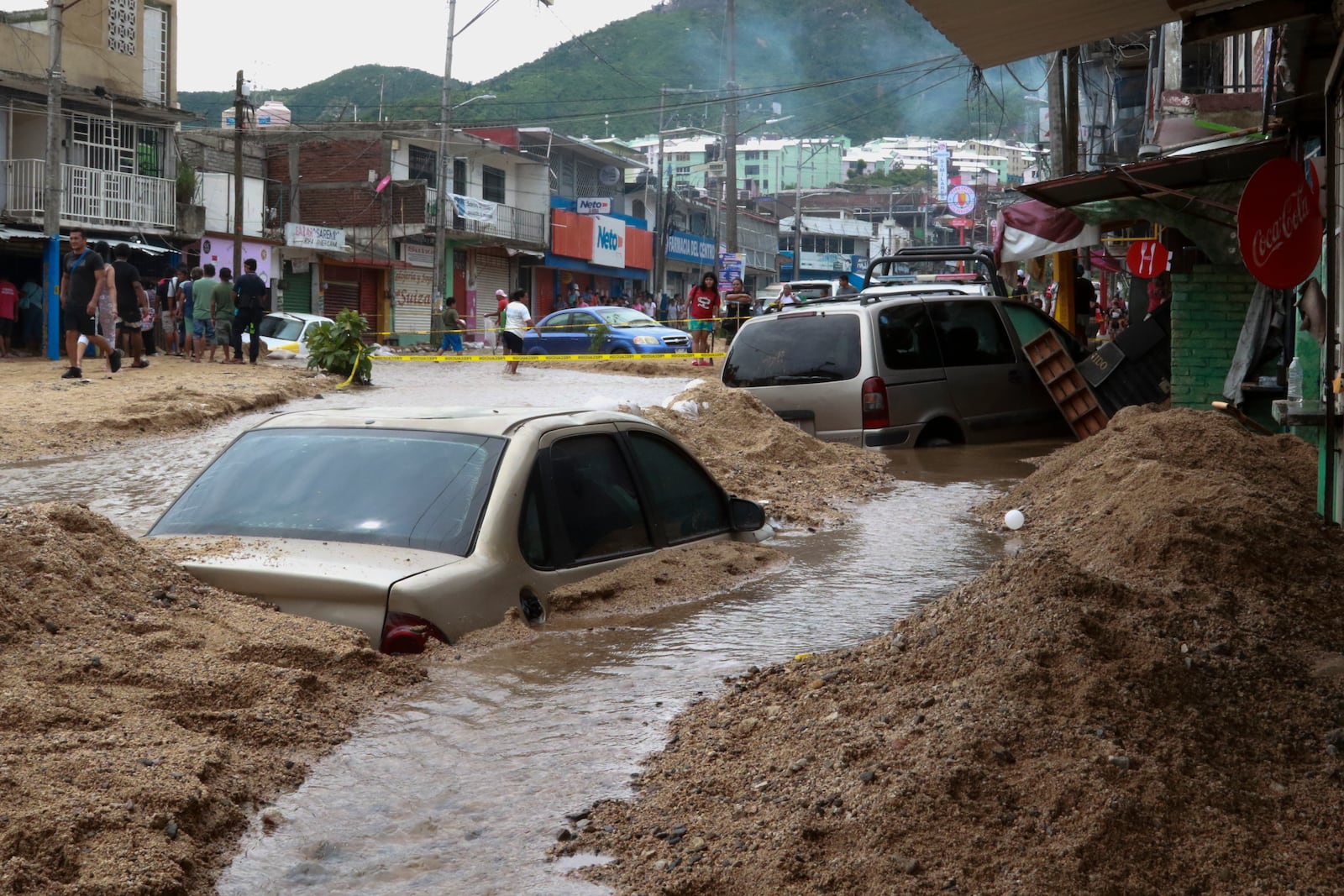 Vehicles are partially submerged on a flooded street in the aftermath of Hurricane John in Acapulco, Mexico, Saturday, Sept. 28, 2024. (AP Photo/Alejandrino Gonzalez)