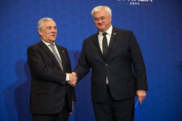 Italian Foreign Minister Antonio Tajani, left, welcomes Ukrainian Foreign Minister Andrii Sybiha for a family photo at the G7 of foreign Ministers in Fiuggi, some 70 kilometers south-east of Rome, Tuesday, Nov. 26, 2024. (AP Photo/Alessandra Tarantino, Pool)