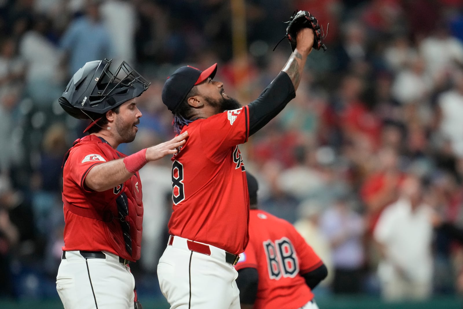 Cleveland Guardians relief pitcher Emmanuel Clase, front right, celebrates with catcher Austin Hedges, left, after they defeated the Minnesota Twins in a baseball game Monday, Sept. 16, 2024, in Cleveland. (AP Photo/Sue Ogrocki)