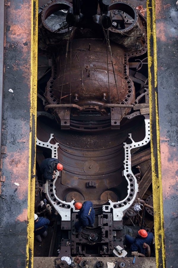 Worker repair equipment at DTEK's power plant after a recent Russian missile attack in Ukraine, Nov. 28, 2024. (AP Photo/Evgeniy Maloletka)