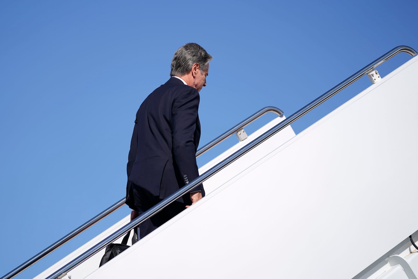 Secretary of State Antony Blinken walks to board a plane en route to the Middle East as he departs Joint Base Andrews, Md., Monday, Oct. 21, 2024. (Nathan Howard/Pool Photo via AP)