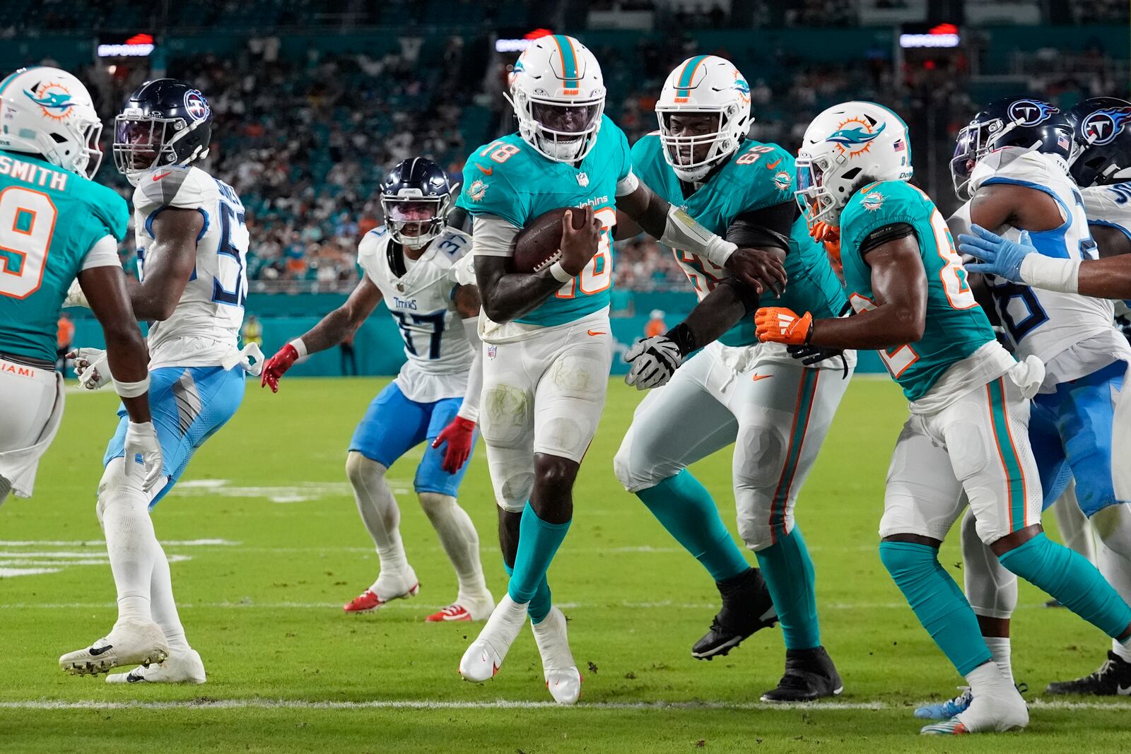 Miami Dolphins quarterback Tyler Huntley (18) scores a touchdown during the second half of an NFL football game against the Tennessee Titans, Monday, Sept. 30, 2024, in Miami Gardens, Fla. (AP Photo/Rebecca Blackwell)