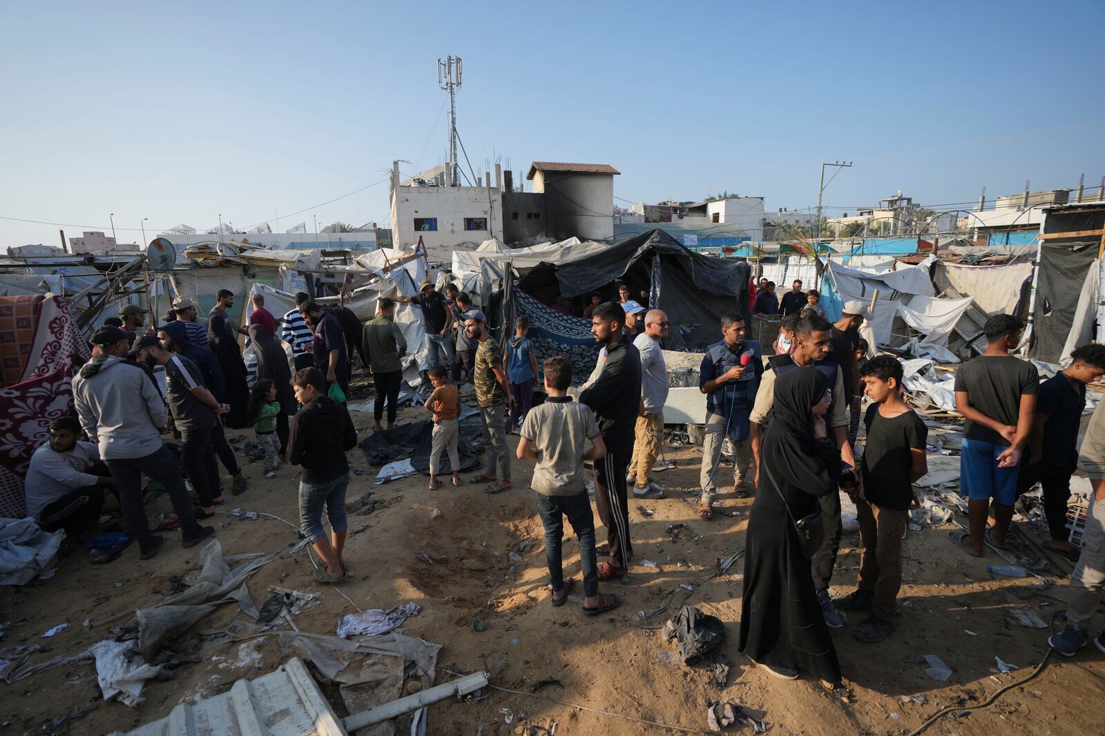 FILE - Palestinians gather at the site of an Israeli strike in the courtyard of the Al-Aqsa Hospital where displaced people live in tents, in Deir al-Balah, Gaza Strip, on Nov. 9, 2024. (AP Photo/Abdel Kareem Hana, File)