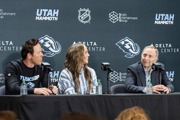 Chairman of Smith Entertainment Group Ryan Smith, Co-Founder Ashley Smith and NHL Commissioner Gary Bettman, from left, announce the Utah Mammoth as the new name and branding identity of Utah's NHL franchise, Wednesday, May 7, 2025, in Salt Lake City. (AP Photo/Melissa Majchrzak)