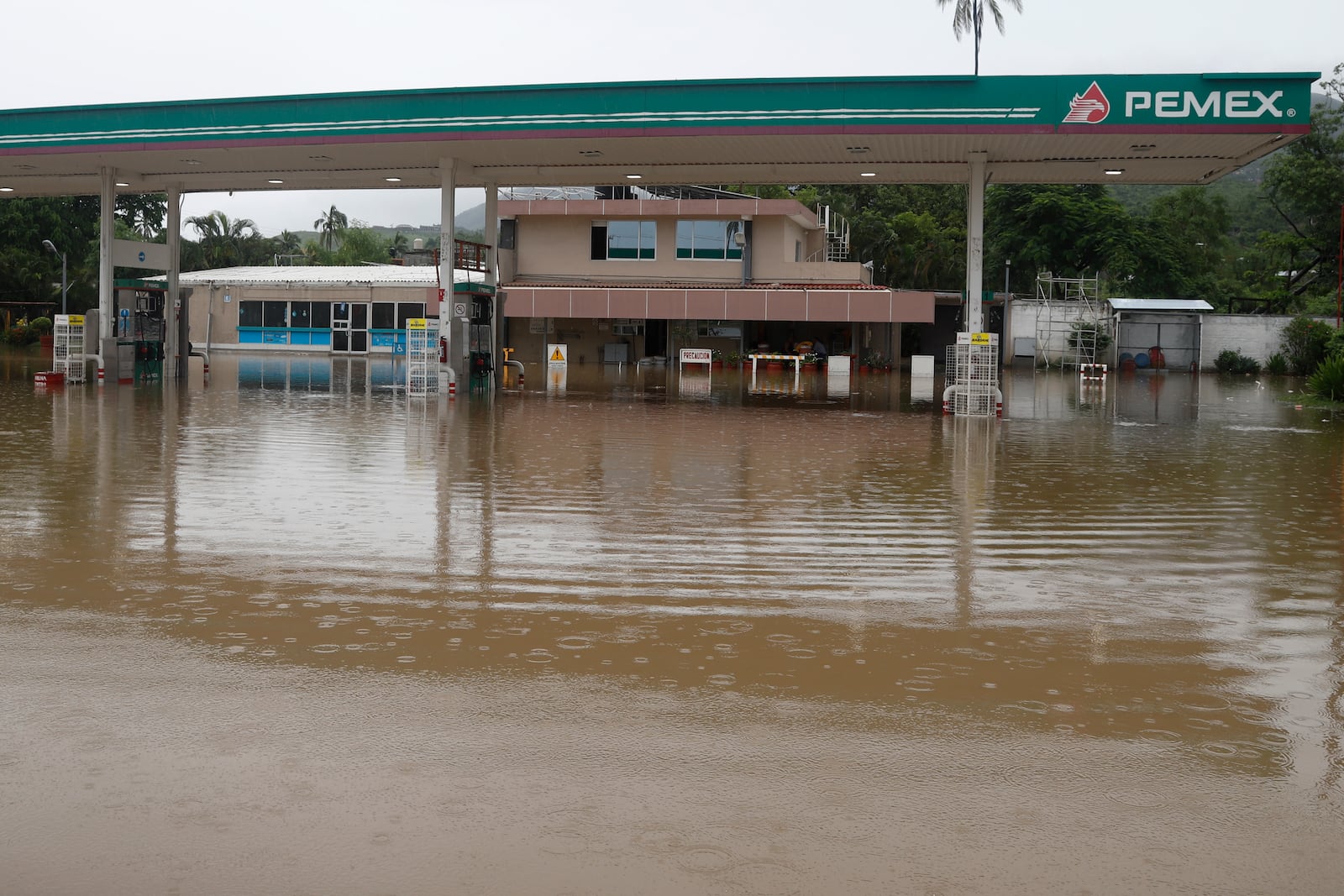 A gas station sits partially submerged by floodwaters in the aftermath of Hurricane John, in Acapulco, Mexico, Friday, Sept. 27, 2024. (AP Photo/Bernardino Hernandez)