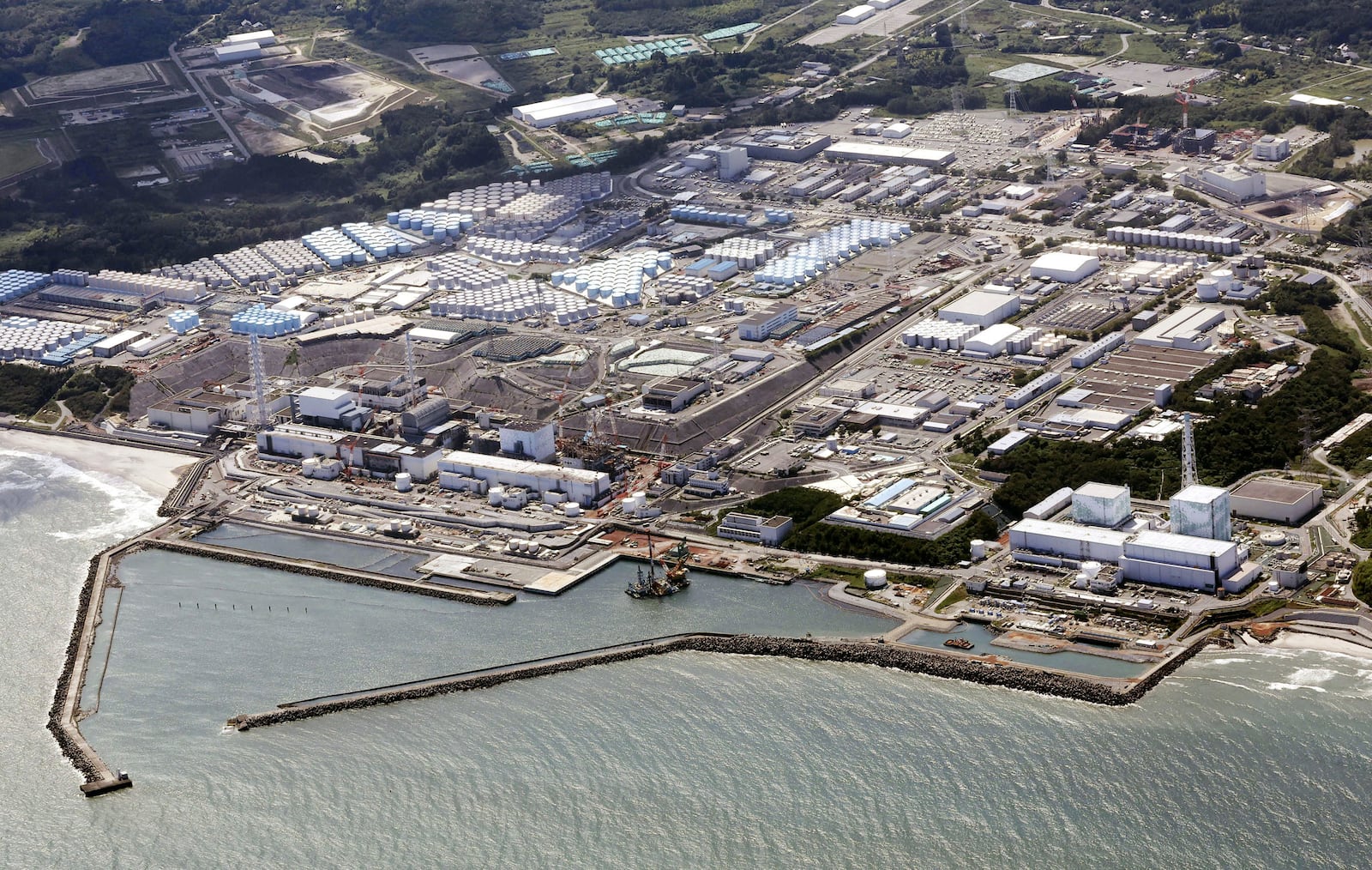 FILE - This aerial view shows the Fukushima Daiichi nuclear power plant in Fukushima, northern Japan, on Aug. 24, 2023, shortly after its operator Tokyo Electric Power Company Holdings TEPCO began releasing its first batch of treated radioactive water into the Pacific Ocean. (Kyodo News via AP, File)