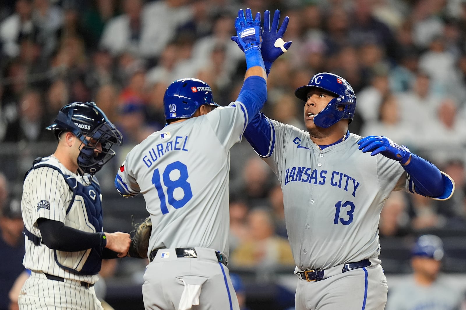 Kansas City Royals' Salvador Perez (13) celebrates with Yuli Gurriel (18) after hitting a solo home run against the New York Yankees during the fourth inning of Game 2 of the American League baseball playoff series, Monday, Oct. 7, 2024, in New York. (AP Photo/Frank Franklin II)