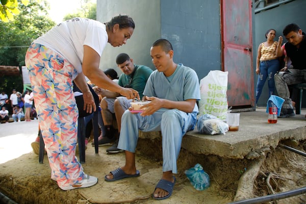 Jesus Salazar, detained during a government crackdown following anti-government protests against the results of the presidential election, receives a meal upon his release from the Yare 3 prison, in San Francisco de Yare, Venezuela, Saturday, Nov. 16, 2024. (AP Photo/Cristian Hernandez)