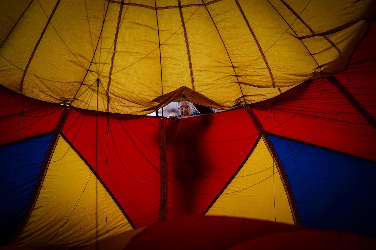 Denise Morgan helps set up the Saki Bomber hot air balloon during Albuquerque Aloft event at Dennis Chavez Elementary School in Northeast Albuquerque, N.M., on Friday, Oct. 4, 2024. (Chancey Bush/The Albuquerque Journal via AP)