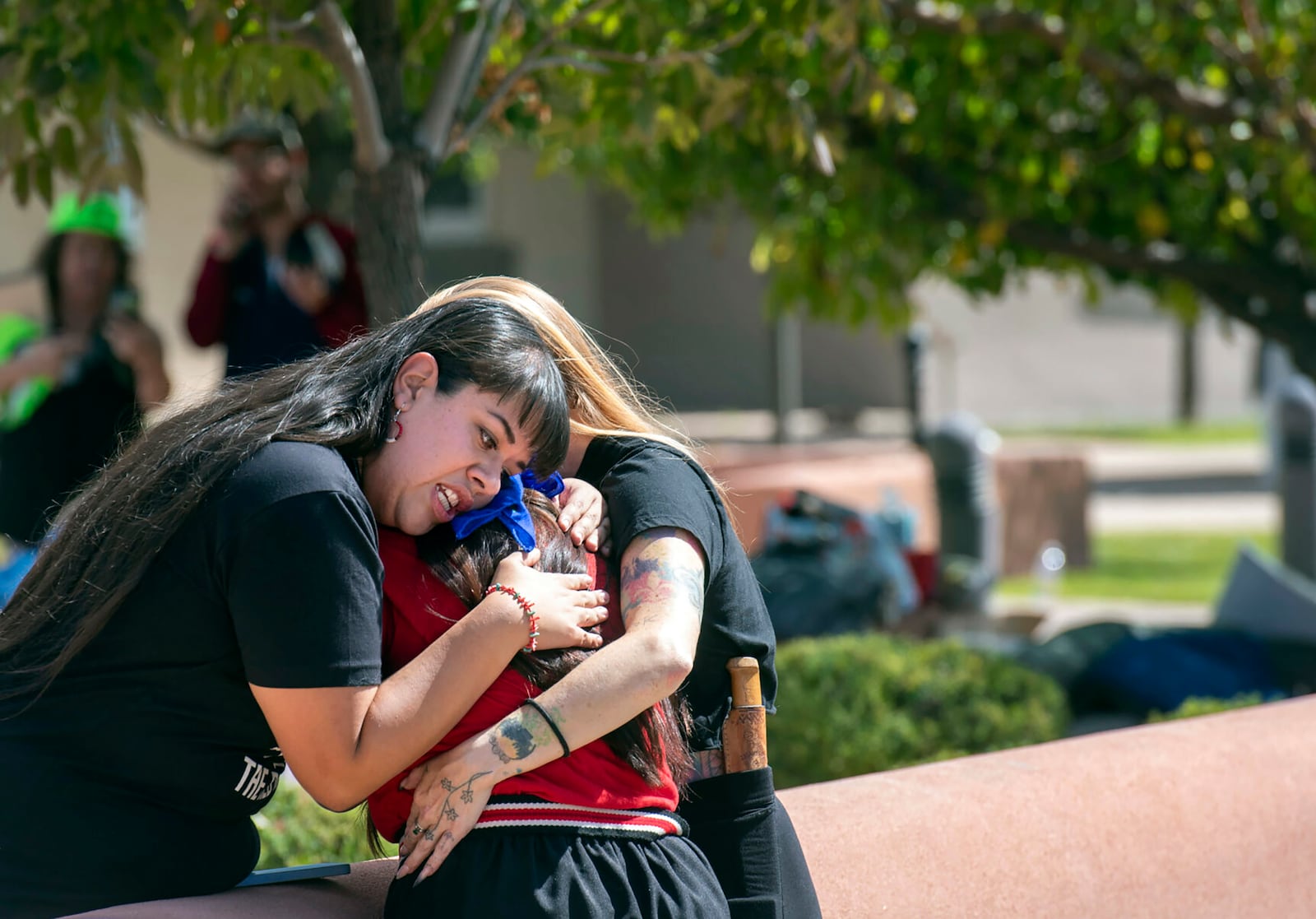 FILE - Jennifer Marley, San Ildefonso Pueblo, and others hug after a man was shot during a rally to protest a statue of Juan Onate that was to be resurrected outside the Rio Arriba County building, in Espanola, N.M., Thursday, Sept. 28, 2023. (Eddie Moore/The Albuquerque Journal via AP, File)