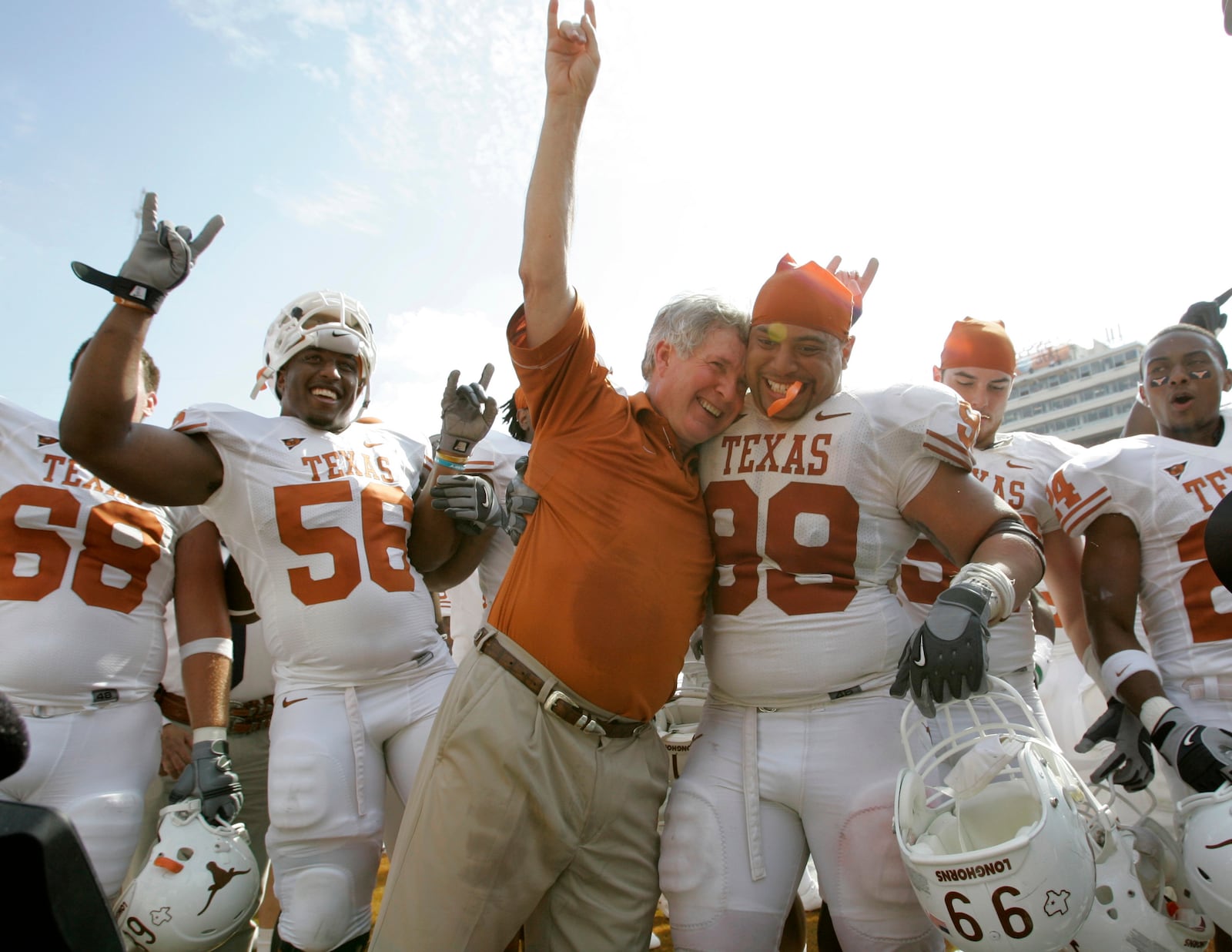 FILE - In this Oct. 11, 2008, file photo, Texas coach Mack Brown celebrates with Texas defensive tackle Roy Miller (99) and others after beating No. 1 Oklahoma 45-35 in an NCAA college football game in Dallas.AP Photo/Tony Gutierrez, File)