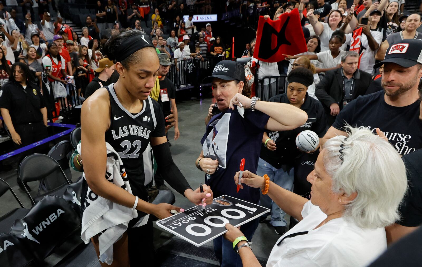 Las Vegas Aces center A'ja Wilson (22) signs autographs for fans after an WNBA basketball game against the Connecticut Sun Sunday, Sept. 15, 2024, in Las Vegas (Steve Marcus/Las Vegas Sun via AP)