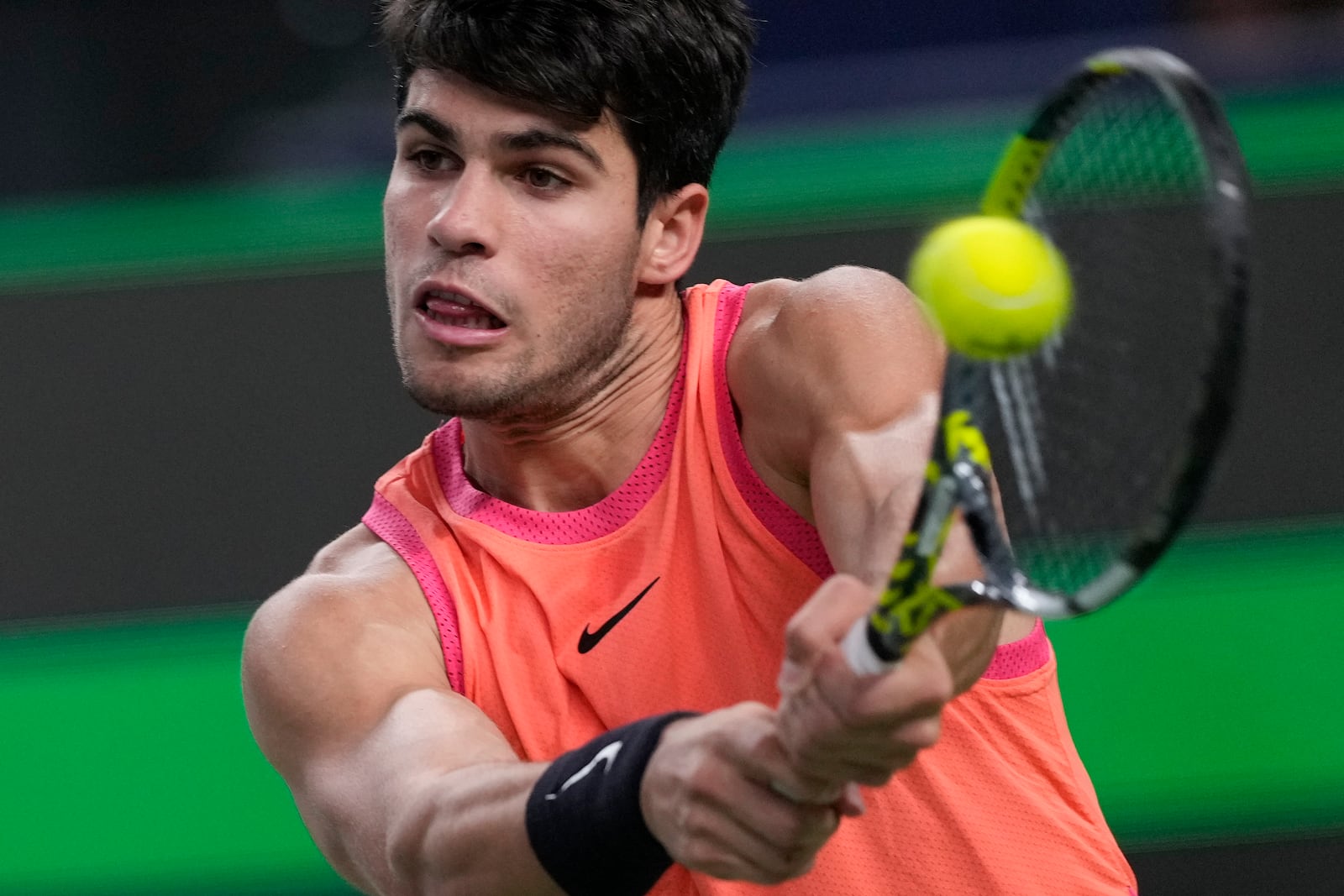 Carlos Alcaraz of Spain plays a backhand return against Tomas Machac of the Czech Republic during the men's singles quarterfinals match in the Shanghai Masters tennis tournament at Qizhong Forest Sports City Tennis Center in Shanghai, China, Thursday, Oct. 10, 2024. (AP Photo/Andy Wong)