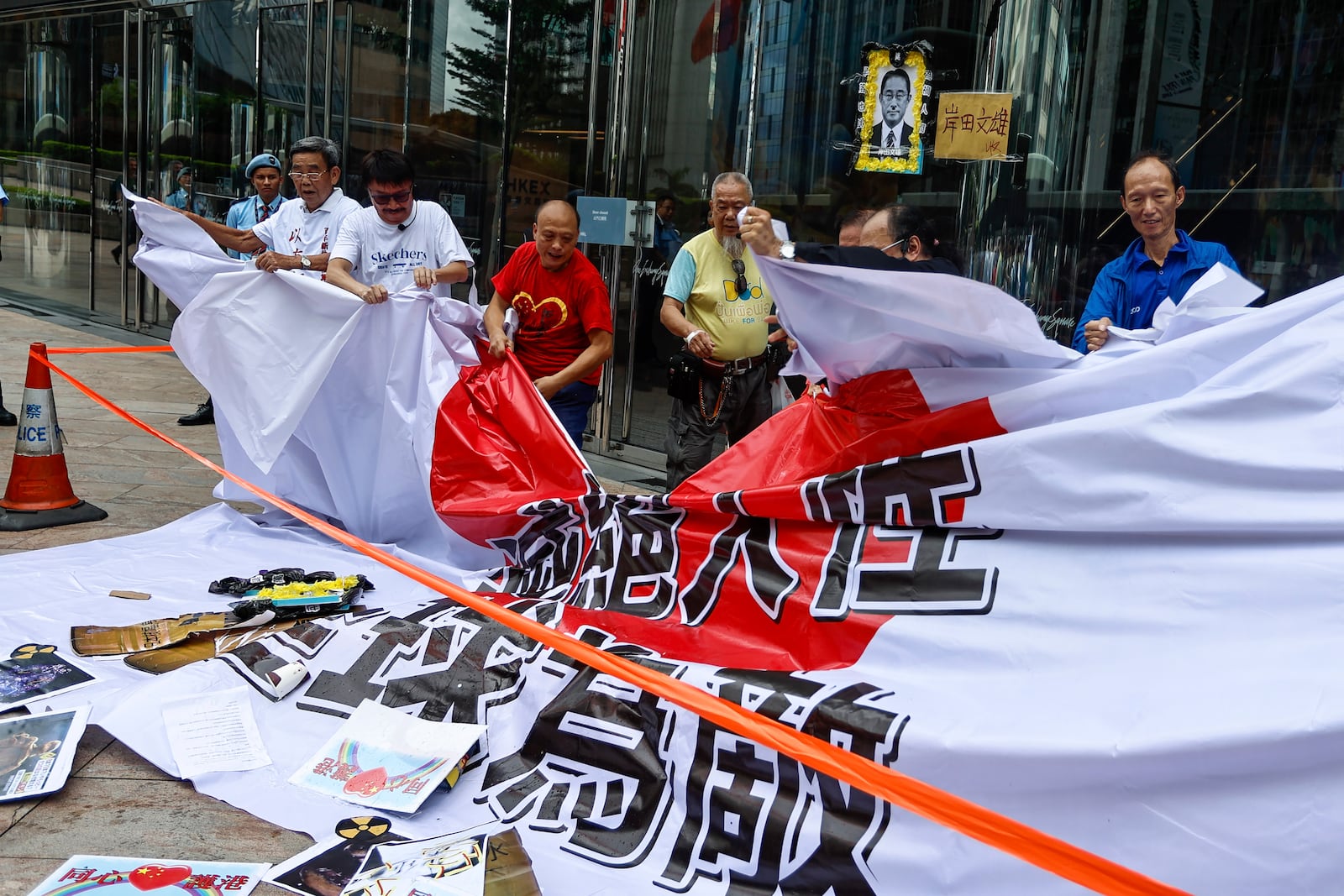 FILE - Protesters tear up a giant Japanese flag with the words "Inhumane, Global Enemy" during a protest against the discharge of treated Fukushima radioactive wastewater, outside the Japan general-consulate in Hong Kong, on Aug. 24, 2023. (AP Photo/Daniel Ceng, File)