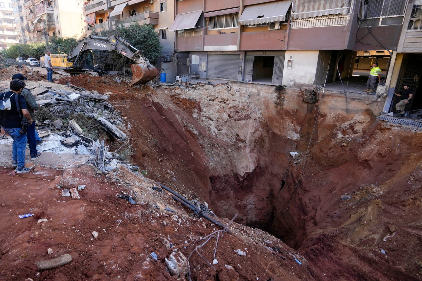 A hole in the ground near the site of the assassination of Hezbollah leader Hassan Nasrallah in Beirut's southern suburbs, Sunday, Sept. 29, 2024. (AP Photo/Hassan Ammar)