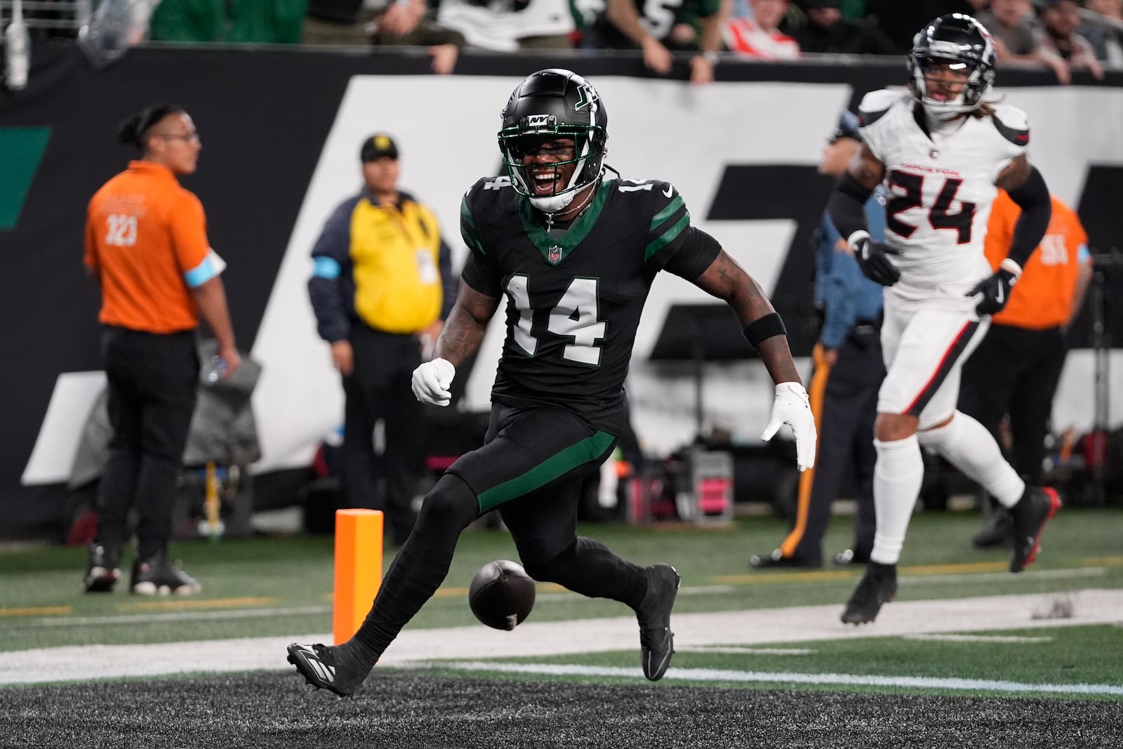 New York Jets wide receiver Malachi Corley (14) drops the ball before scoring a touchdown during the first half an NFL football game against the Houston Texans, Thursday, Oct. 31, 2024, in East Rutherford, N.J. (AP Photo/Frank Franklin II)